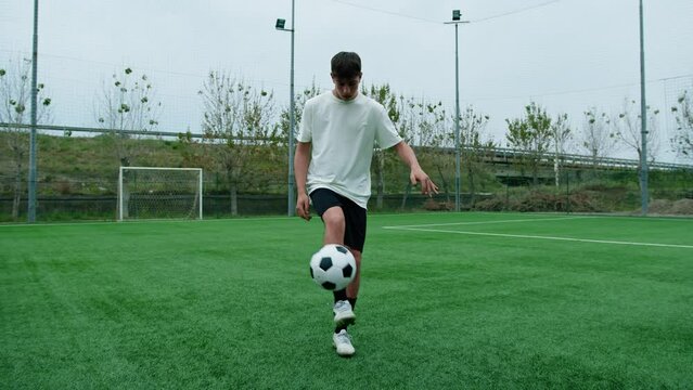Young Male Player Dribbles In Freestyle Soccer Field