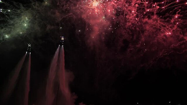 flyboarding against the background of fireworks in the night sky, fireworks