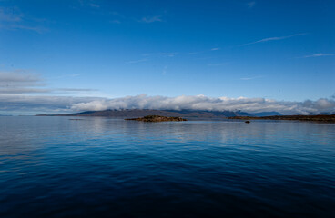 Naklejka premium Blue Ocean scene with clear sky. Isle of Skye Scotland UK. Winter coastal landscape. Cold water