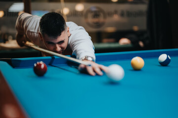 Joyful leisure time as a focused young man plays pool, demonstrating skill and precision in a...