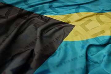 waving colorful national flag of bahamas on a euro money banknotes background. finance concept.
