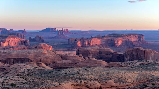 Sunrise over famous Hunts Mesa in Monument Valley shows the ruggedness and desert shapes where may old western movies were filmed