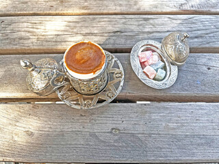 Traditional Turkish coffee and Turkish delight on a wooden table.