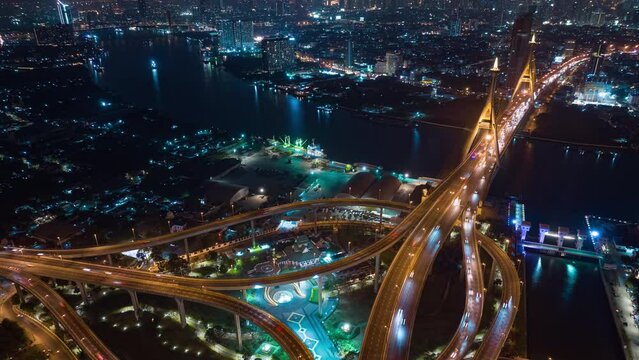 night illuminated bangkok city traffic street road interchange famous riverside bridge aerial topdown panorama 4k timelapse thailand
