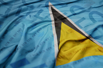 waving colorful national flag of saint lucia on a euro money banknotes background. finance concept