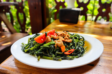 Tumis kangkung, an indonesian food. Stir fried water spinach or morning glory or kale