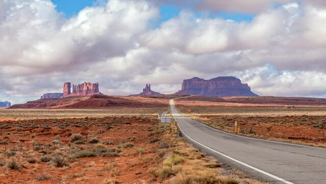 Timelapse of famous Forrest Gump Highway between Arizona and Utah highlights dramatic cloud movement and ground shadows as cars zoom by