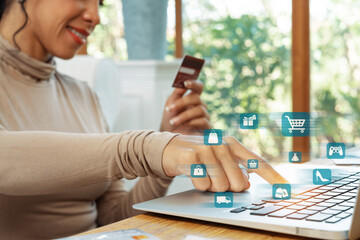 Elegant customer wearing brown shirt holding credit card choosing online platform. Smart consumer...