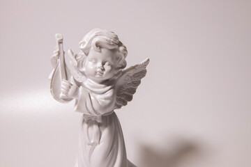 Sad guardian angel sculpture with open long wings across