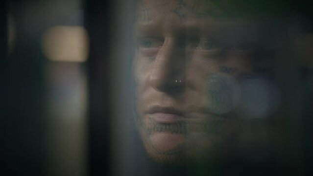 Intimidating Maverick Rebel Man with Head and Face Tattoos in Provoking Style