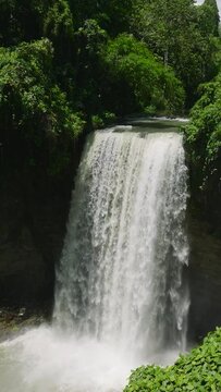 Waterfall in a tropical forest. Aerial survey of Hikong Alo Falls. Lake Sebu. Mindanao, Philippines. Travel concept. Vertical view.