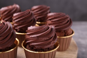 Delicious chocolate cupcakes on grey table, closeup