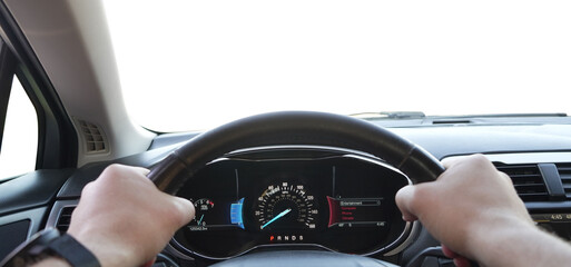 Man driving car with speedometer on dashboard, closeup