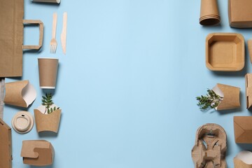 Flat lay composition with eco friendly food packagings and twigs on light blue background. Space...
