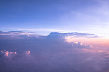 An aerial shot above beautiful sunset, sunrise clouds. Sunset above the clouds from airplane...