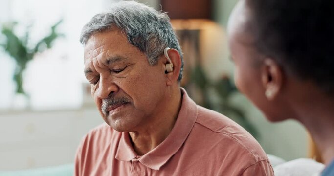 Nurse, patient and hearing aid on ear for medical support, wellness and innovation of disability. People, healthcare worker and deaf man with audiology implant, service or help for sound waves