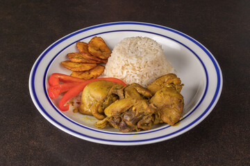 A plate of Jamaican curried goat without sauce with rice and plantain