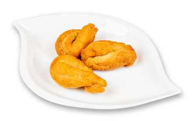 A white plate with three Jamaican or baked or fried sweet Caribbean Festivals isolated on white