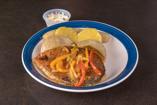 A plate of Jamaican or Trinidad king fish with dumplings