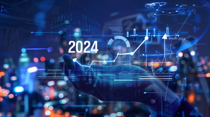 Businessman hand holding white hologram of text "2024" and icons arrow up with graph chart growth in business strategy plan for success concept on virtual screen background at night cityscape