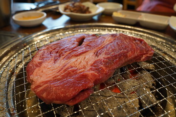 Thick beef grilled directly on a charcoal grill