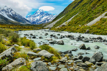 Glacial stream between rocks and gravel in Hooker Valley from Aoraki Mount Cook, highest peak of...