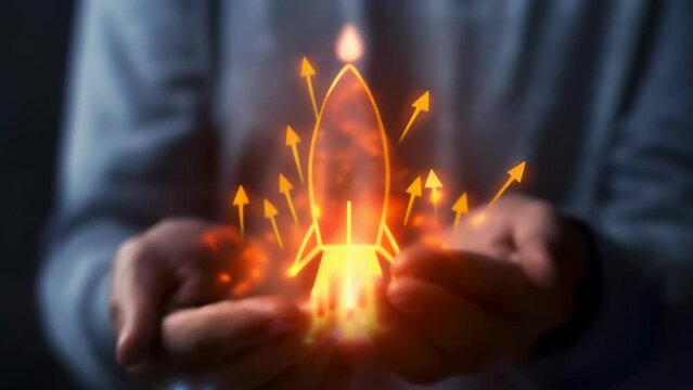 Hands cradle glowing rocket icon with upward arrows, embodying a startup's rapid growth, ambitious vision, and innovative spirit. Symbolic image captures the potential for exponential success.
