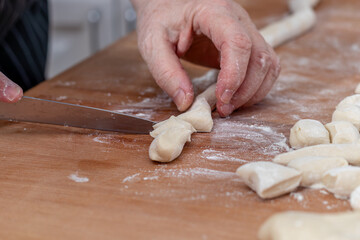 Woman kneading dough in kitchen.Women's hands knead the dough for dumplings.