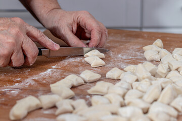 Woman kneading dough in kitchen.Women's hands knead the dough for dumplings
