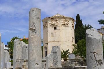 The Tower of the Winds, or Horologion of Andronikos Kyrrhestes, an ancient clocktower, seen through the columns of the eastern Propylon (entrance) of the Roman Agora (market), In Athens, Greece