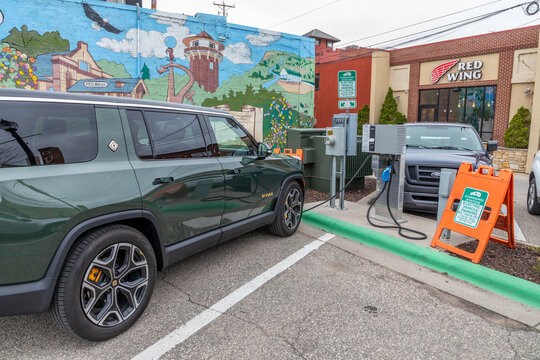 A Rivian electric vehicle charges at the Red Wing Minnesota Public Electric Vehicle Charging Station located in downtown area in Spring 2024