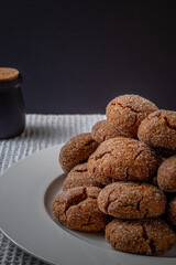 Warm Homemade Gingersnap Cookies on a dark background