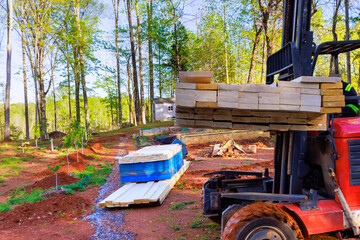Contractor using forklift working on delivery construction of building materials in construction site