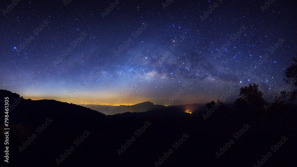 Wall mural panorama silhouette tree on high mountain with milky way galaxy, night starry sky with stars