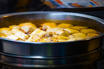 a street food stall where freshly prepared spicy stinky tofu is on display