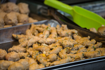 a street food stall where freshly prepared pork thicks are on display