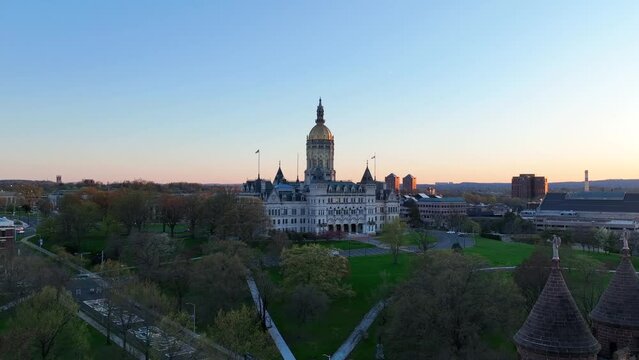 Drone video of the Connecticut State Capitol Building in Hartford, CT at dusk - Aerial view over Bushnell Park