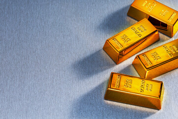 Top view of gold bars on grey surface with place for text.  finance trading investment business economy concept.