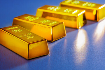 gold bars on blue background.  set of gold bars. concept of wealth, rich, trading gold.