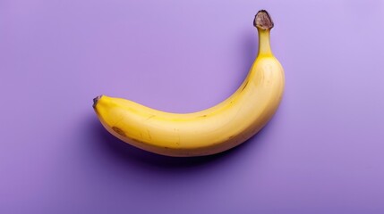 Banana on a purple background. An exotic fruit. Delicious and juicy bananas are bright yellow in color.