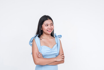Young Asian woman in a stylish blue dress posing with confidence, isolated on a white background