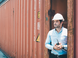 Portrait of a handsome engineer under inspection and checking production process on dock station...