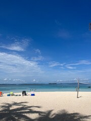 A serene beach on San Blas Island, Panama, featuring a blue sky, white sand, a volleyball net, and crystal-clear blue waters. Perfect for relaxation and beach sports in a tropical paradise