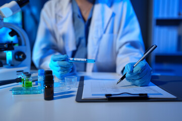 Scientists record data using drug sampling tubes for analysis and testing. Advanced science...