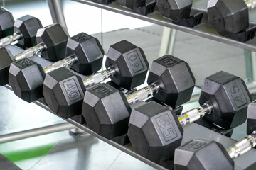 Rows of dumbbells weight in pounds in the gym of modern dumbbells equipment in the sport