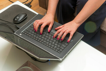 Fototapeta na wymiar Female hands working on laptop, business, typing, writing