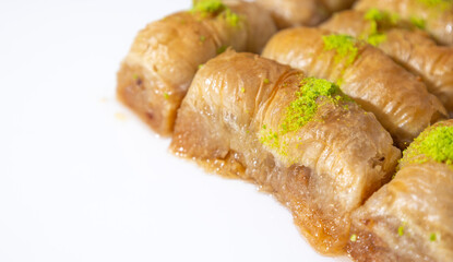 Turkish Baklava on white ground, desset with pistachio on top, close up dessert photo.