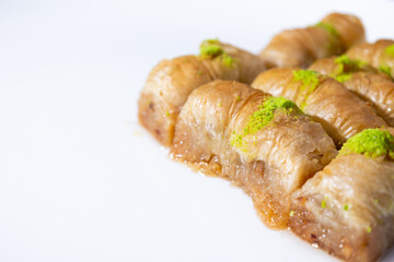 Turkish Baklava on white ground, desset with pistachio on top, close up dessert photo.