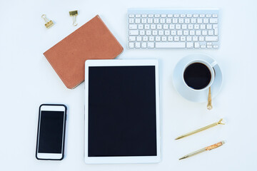 Tablet, phone and blank screen above for social media, tech and business for content creation work. Desk, creative and workspace with startup with ux technology and coffee in a seo app office
