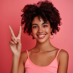 young pretty black African American woman gesturing peace or victory sign with her fingers